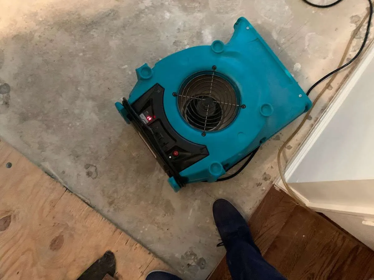 Air mover drying subfloor during Commercial Water Damage Restoration in Bell Gardens